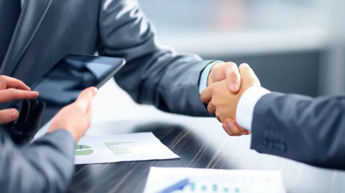 Expert Finance Broker shaking hands with client